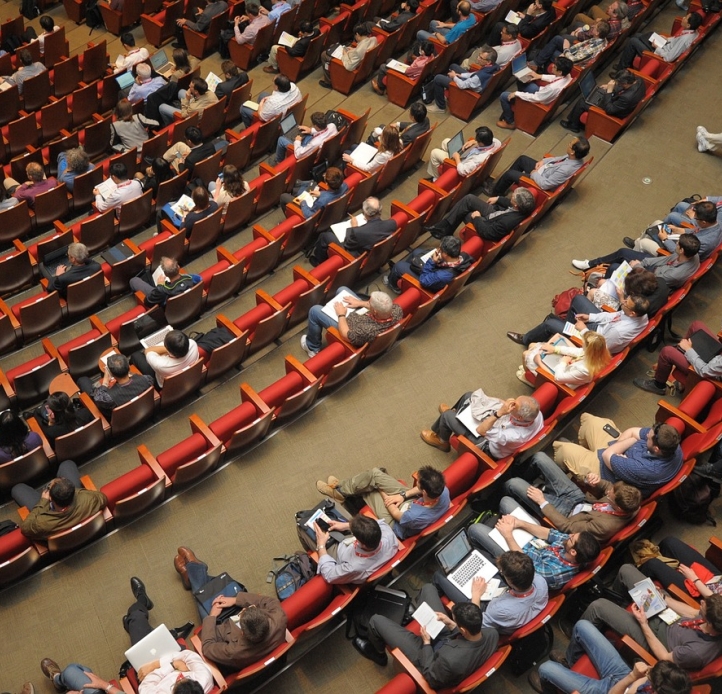 event auditorium with people sitting in chairs