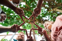 People holding their fingers to form a star